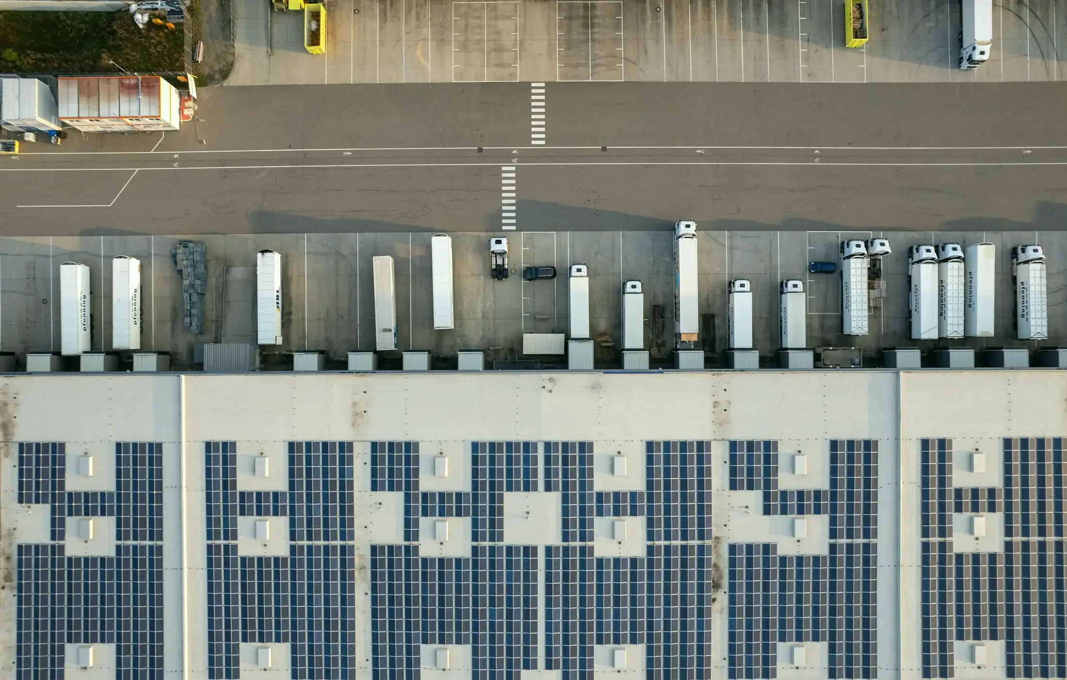Trailers backed into the dock doors of a distribution center, seen from above