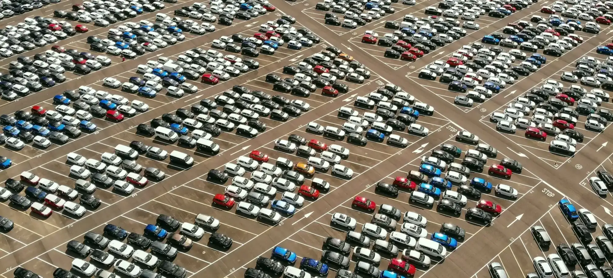 Rows of new vehicles on a lot, seen from above