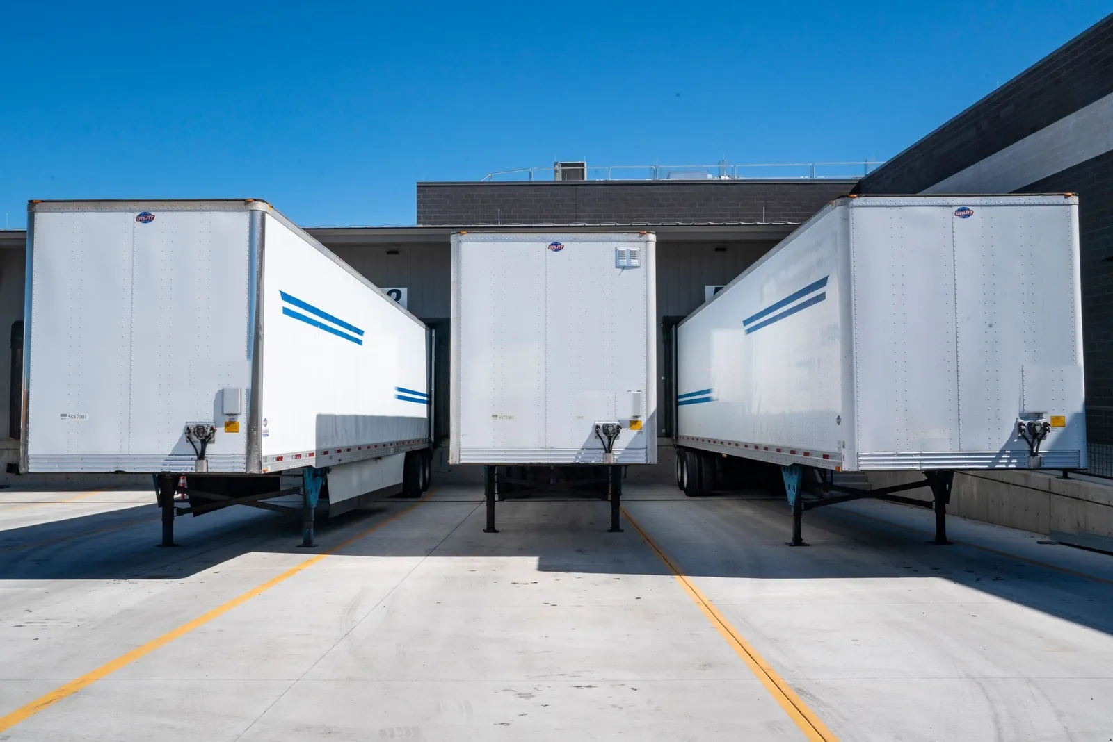 Dry van trailers backed into a distribution center loading dock